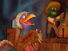 the puppets are dressed in costumes and playing instruments