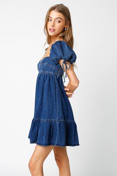 Throw on the Jessie Dark Denim Babydoll Mini Dress and meet your friends for brunch! Woven dark denim fabric shapes a sweetheart neckline, empire bodice, and puffy short sleeves with ties and elasticized shoulders. The babydoll silhouette continues to a flirty mini skirt with a ruffle hem. DETAILS & FIT S: 29" Length, 24" Bust, 44" Hips M: 30" Length, 26" Bust, 46" Hips L: 30.5" Length, 29" Bust, 48" Hips 85% Cotton, 15% Polyester. Machine wash cold. Imported. Denim Dress Outfit, Denim Baby, Babydoll Mini Dress, Denim Accessories, Gameday Outfit, Babydoll Dress, Dark Denim, Denim Fabric, Ruffle Hem