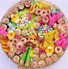 a basket filled with lots of different types of doughnuts and candies next to each other