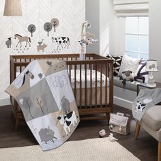 a baby's room with animals and trees on the wall