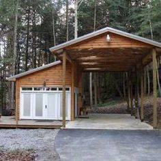 a small wooden building sitting in the middle of a forest