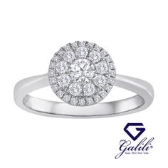 a white gold ring with diamonds in the center and an oval halo setting on top