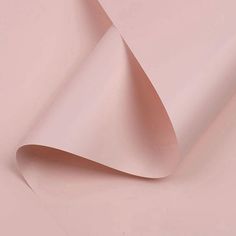 an image of a pink paper with some folds on the side and one corner missing