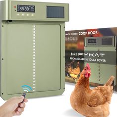 a chicken laying on the ground next to a coop door and remote control box for chickens