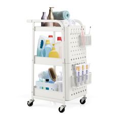 a white cart with three shelves filled with bottles and cleaning supplies on wheels, against a white background