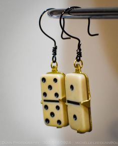 Show off your quirky and fun style with these one-of-a-kind dangle earrings made from recycled dominoes. Perfect for anyone who loves unique and playful accessories, these earrings combine vintage charm with modern flair. Key features include: Design: Recycled dominoes set into a sleek brass setting, creating a distinctive and eye-catching look. French wire ear hooks made of silver, coated in black for a striking contrast and modern finish. Materials: Authentic vintage dominoes, repurposed into Junk Earrings, Dominoes Set, Food Earrings, Stylish Earrings, Silver Coat, Stylish Earring, French Wire, Fun Style, Ear Hook