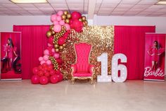 a pink and gold birthday party with balloons on the wall, balloon arch and chair