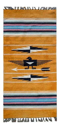 an orange rug with black and white stripes on it, featuring a small airplane in the middle