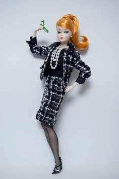 a barbie doll is dressed in black and white