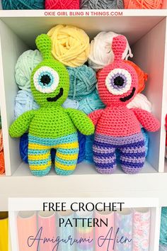 two crocheted stuffed animals sitting on top of a shelf next to balls of yarn