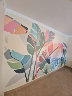 an empty room with a large mural on the wall