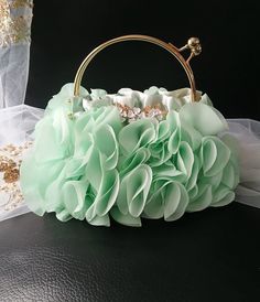 This stunning Sage Green Chiffon Evening Clutch Bag is the perfect accessory for weddings and special events. Adorned with delicate flowers, this elegant handbag is ideal for both brides and bridesmaids. The gold hardware adds a touch of glamour, making this purse a must-have for any formal occasion. Stay stylish and organized with this chic clutch bag that will complement any outfit beautifully. Size: 23cmx22cmx9cm(LxHxW) Colour: sage green -------------------- International Shoppers: Please se Green Handheld Clutch For Wedding, Handheld Green Clutch For Wedding, Green Clutch Evening Bag For Wedding, Bridesmaid Purses, Bag With Flowers, Wedding Handbag, Wedding Bags, Accessories Bags Purses, Delicate Flowers