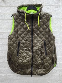 Introducing the brand new Herno Mesh Lined Quilted Hoodie Ultralight Vest in Verde Militare. This stunning vest is perfect for any woman looking for a stylish and functional addition to their wardrobe. It features a mid-length cut, sleeveless design, and a zip closure for easy on and off access. This vest is water-resistant, making it perfect for outdoor activities regardless of the weather. With zipped pockets and a hood, this vest is perfect for carrying your essentials and keeping your head a Sporty Nylon Hoodie For Winter, Winter Sportswear Nylon Hoodie, Winter Athleisure Nylon Hoodie, Green Athleisure Hooded Jacket For Winter, Green Stretch Hooded Outerwear, Green Athleisure Outerwear With Drawstring Hood, Green Stretch Outerwear For Streetwear, Athleisure Green Hooded Outerwear, Green Hooded Athleisure Outerwear