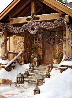 a house covered in snow with lots of lanterns