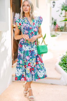 Welcome in the bright days ahead with this navy blue floral midi dress! Feel free to make a statement and stand out with the bold and bright floral print while the classic midi silhouette and flirty ruffled cap sleeves keep you looking timelessly chic. Perfect for any occasion and guaranteed to add a little extra sunshine to any wardrobe! This midi dress features ruffled cap sleeves, pockets, a split v-neckline, tiered body, and a colorful floral print.  Material has no amount of stretch.Cam is Navy Blue Floral Dress, Blue Floral Midi Dress, Floral Cocktail Dress, Black Tie Dress, Long Sleeve Outerwear, Two Piece Swimwear, Floral Blue Dress, Friend Outfits, Floral Dresses