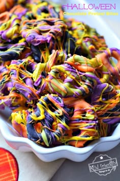 a white bowl filled with colorful sprinkles on top of a table