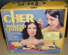 the box is open to show an image of a woman getting her hair done