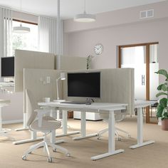 a computer desk with two monitors on it and a chair in front of the monitor