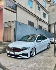 a white car parked in front of a building