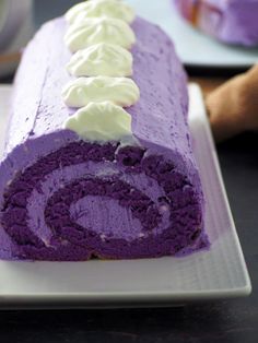 a purple cake with white frosting is on a plate