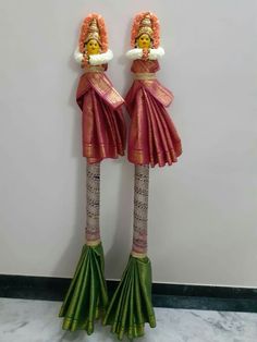 two large wooden statues with flowers on them