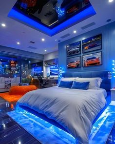 a bedroom with blue lighting and a bed in the middle is lit up at night