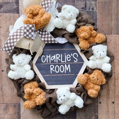 a wreath with teddy bears and a chalkboard that says charlie's room