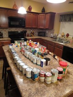 the kitchen counter is full of canned food