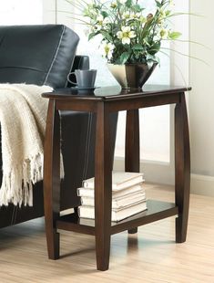 a black leather chair and table with flowers on it