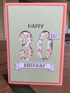 a birthday card with the number 30 on it and flowers in pink, green, and white