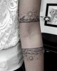 a woman's arm with tattoos on it and an image of a sunflower