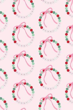 pink and green bracelets with red, white, and green beads are on a light pink background