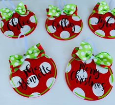 four red christmas ornaments with green polka dots and bows on them that say merry christmas