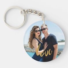 a keychain with the word love on it and a photo of two people