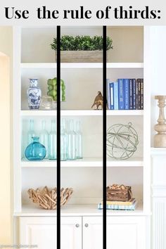 a white bookcase filled with books and vases on top of it's shelves