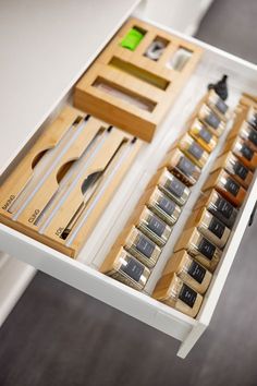 an open drawer filled with assorted items on top of a table