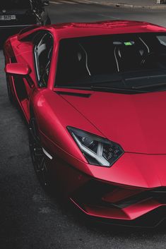 a red sports car parked in a parking lot