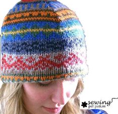 a woman wearing a multi colored knitted hat