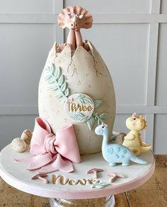 there is a cake that looks like an egg with its baby's name on it