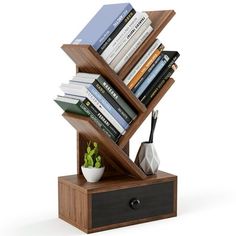 a bookshelf with many books on top of it and a plant in the middle