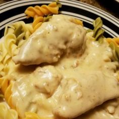 a plate topped with pasta and chicken covered in gravy