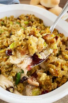 a white bowl filled with stuffing and vegetables