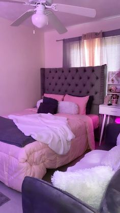 a bed room with a neatly made bed and purple walls