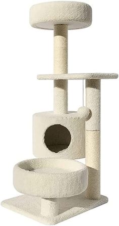 the cat tree is white and has a black hole in it