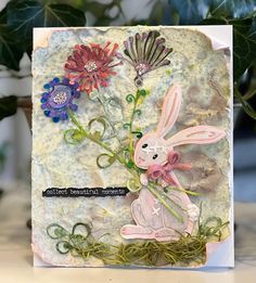 a card with an image of a bunny and flowers