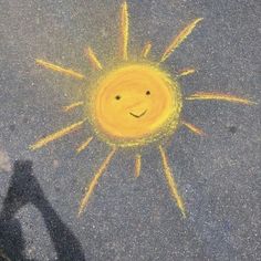 a yellow smiley face drawn on the pavement