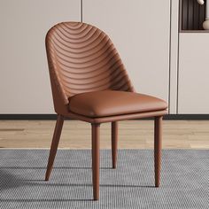 a brown leather chair sitting on top of a rug