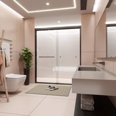 a bathroom with a toilet, sink and shower stall in the middle is lit by recessed lighting