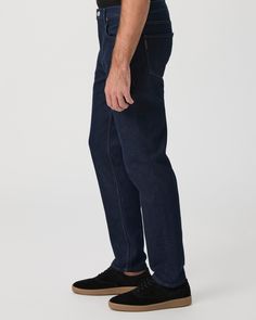 Wilcox is our new relaxed tapered fit, featuring a wider fit throughout the thigh that tapers in at the bottom to a 14” leg opening. This pair is crafted from our new PAIGE Heritage denim in a dark indigo wash with mixed metal hardware. Our Heritage denim offers the same vintage-inspired character while maintaining the soft hand-feel and comfort you’ve come to love and expect from PAIGE. | PAIGE Heritage Wilcox Tapered Jean - Barela Blue | Size 38 Casual Tapered Straight Bottoms, Relaxed Fit Tapered Bottoms For Business Casual, Business Casual Bottoms With Relaxed Tapered Fit, Business Casual Tapered Bottoms With Relaxed Fit, Casual Dark Wash Tapered Pants, Casual Tapered Dark Wash Pants, Everyday Tapered Straight Leg Bottoms, Everyday Tapered Leg Cargo Jeans, Everyday Tapered Leg Jeans