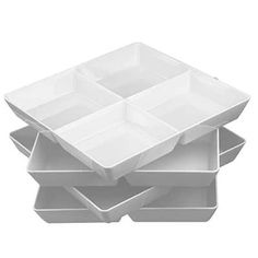 three white trays stacked on top of each other in the shape of four squares